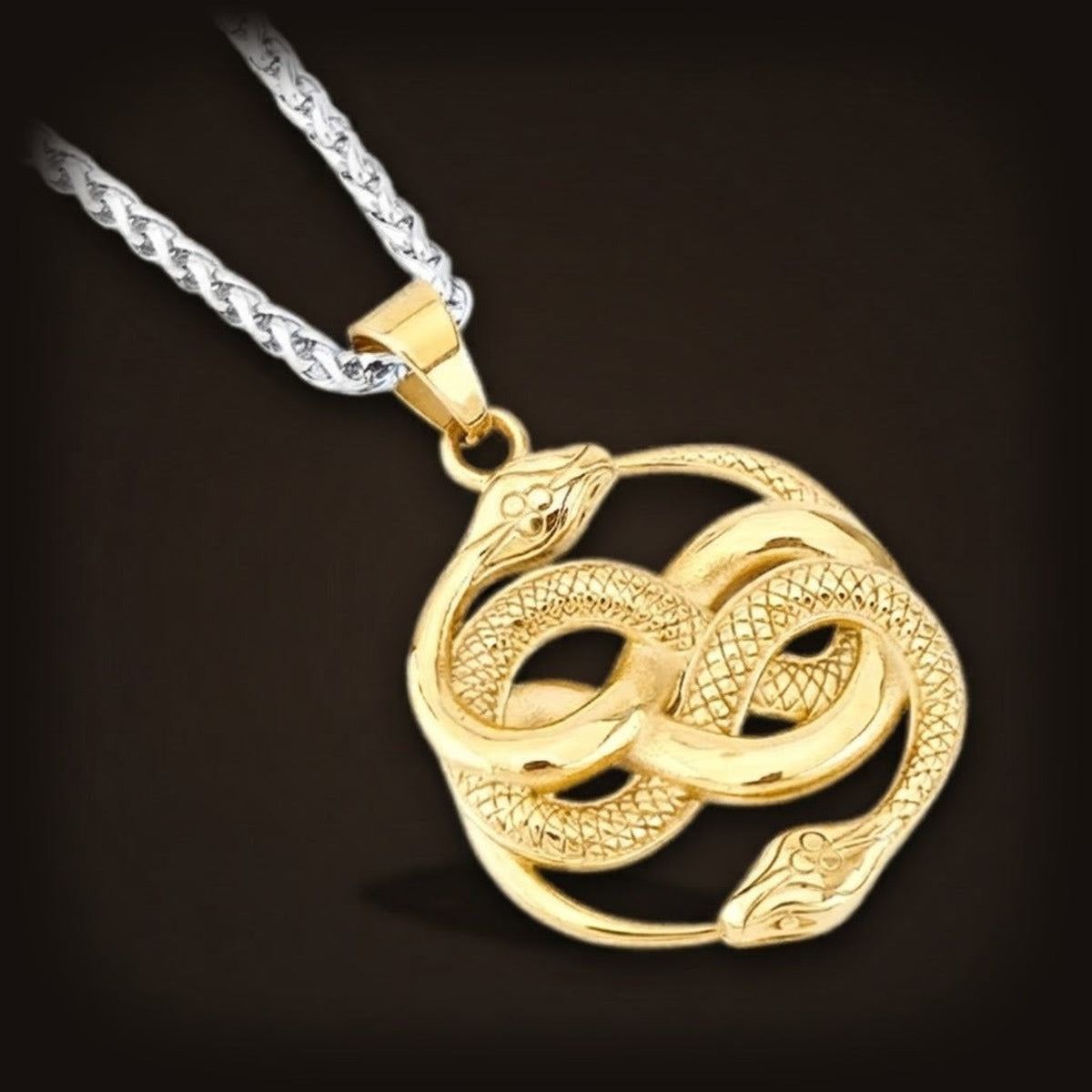 Pendentif doré en acier, deux serpents enroulés l'un dans l'autre en forme de huit, sur sa chaîne tressée